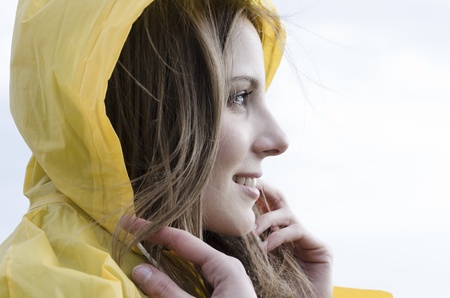 Young woman enjoying a windy day on he beachの写真素材