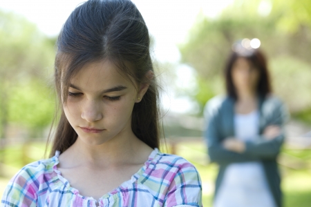 Little girl being told off by her motherの写真素材