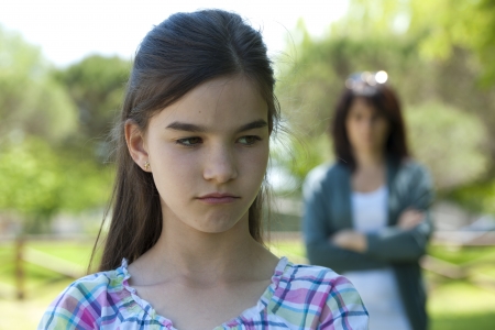 Little girl being told off by her motherの写真素材