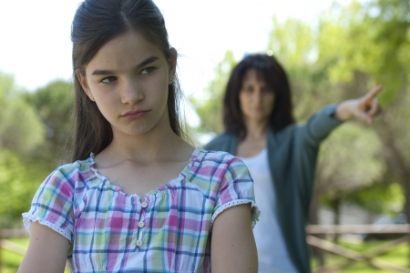 Little girl being told off by her motherの写真素材