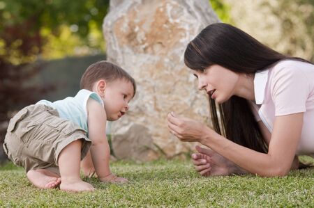 Mother playing with her little boy outdoors