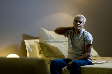 Senior man awake in the bedの写真素材