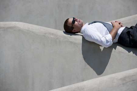 Businessman relaxing outdoorsの写真素材