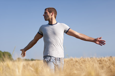 Young man enjoying life, his arms openの写真素材