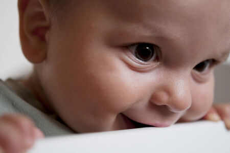 Close-up of a little Baby bitting on cribの写真素材