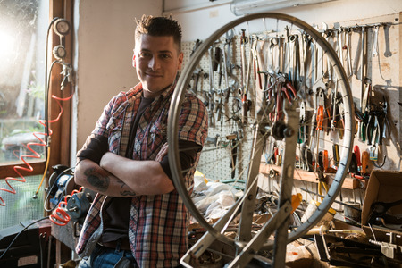 Young man working in a biking repair shop