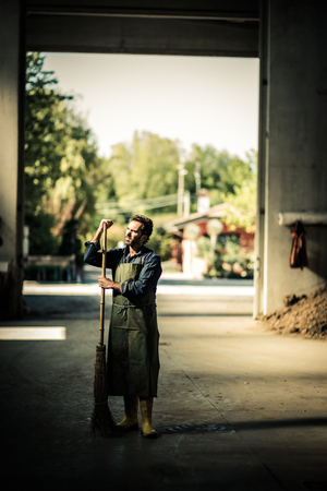 Worker brushing the warehouseの写真素材