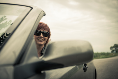 Woman enjoying driving her convertible carの写真素材