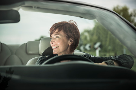 Woman enjoying driving her convertible carの写真素材