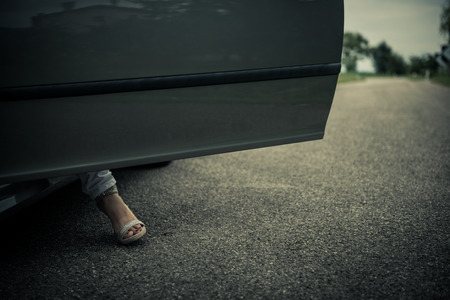 Woman legs next to carの写真素材