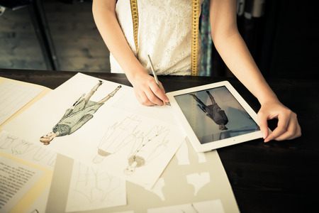 Close-up of a young fashion designer with her hand drawn illustrationのeditorial素材