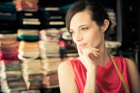 Young woman working at fabric shop; could also be a young ownerの写真素材