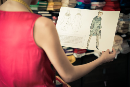 Young fashion designer holding her hand drawn illustrationのeditorial素材