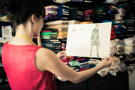 Young fashion designer holding her hand drawn illustrationのeditorial素材