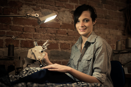Young woman working on sewing machineの写真素材