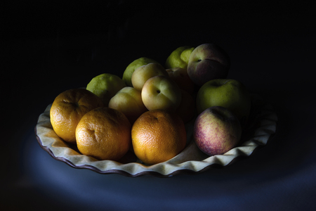 Fruits in a plate lights and shadowsの写真素材