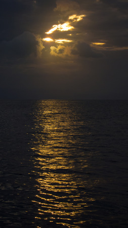very dark atmosphere of the sea at sundownの写真素材