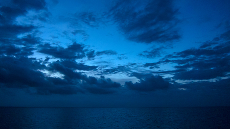dark blue sky Cloudy sky over the sea, blue hourの写真素材