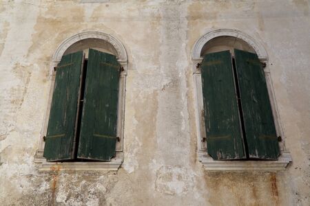 Italy,the windows of the ancient houses of the charming village of Polcenigoの写真素材