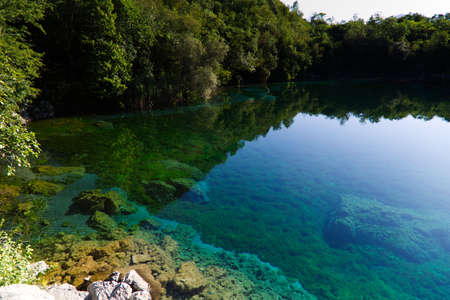 The emerald waters of Lake Cornino in the Cornino regional nature reserve, Italyの写真素材