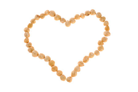 hazelnuts on a white background in the form of heart の写真素材