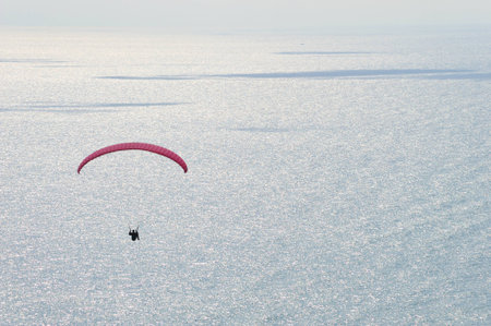 paraglider flying in the sky の写真素材