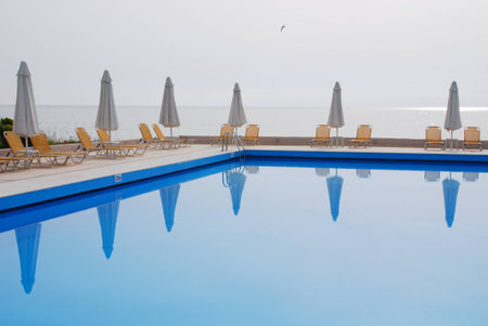 pool with umbrellas and sun bedsの写真素材