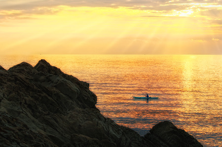 Man kayaking at sunset, Livorno (Tuscany)の写真素材