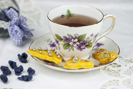 English afternoon tea with cookies and candied violetsの写真素材