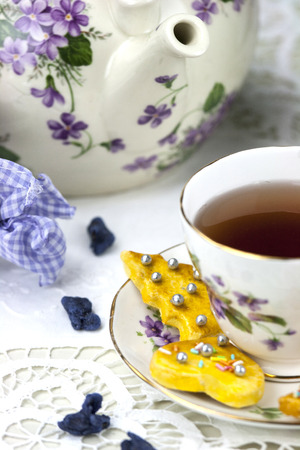 English afternoon tea with cookies and candied violetsの写真素材