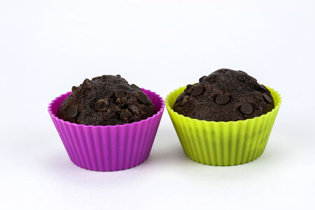Close up of two chocolate muffins on a white backgroundの写真素材