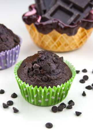 Close up of chocolate muffins on a white table with a lot of chocolate's dropsの写真素材
