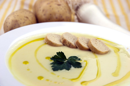Italian potato and leek soup with olive oil, parsley and croutonsの写真素材
