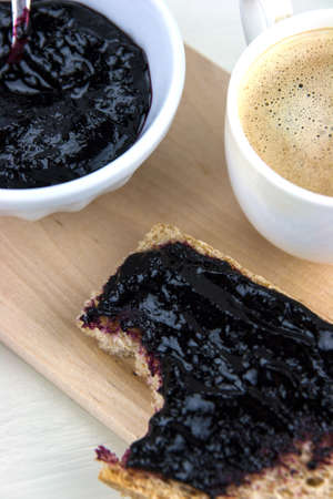 Homemade blueberry jam with integral bread and coffeの写真素材