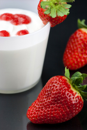 fresh yogurt's mousse with strawberry cream on black background.の写真素材
