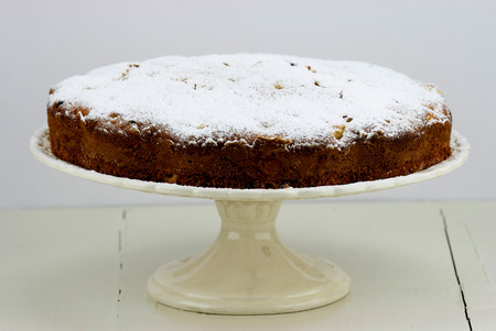 Italian cake with ricotta, pears and drops of chocolate on white and wooden table.の写真素材