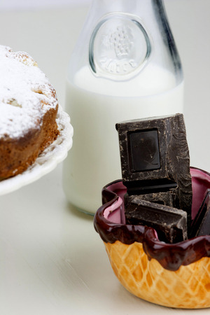 Italian cake with ricotta, pears and drops of chocolate on white and wooden table.の写真素材