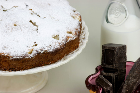 Italian cake with ricotta, pears and drops of chocolate on white and wooden table.の写真素材