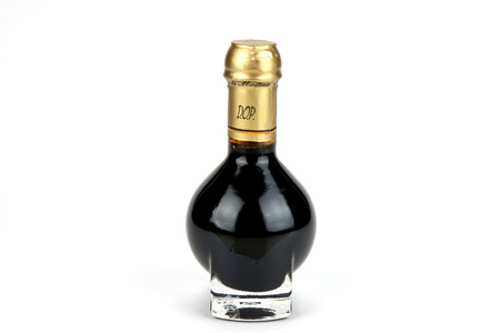 Traditional italian balsamic vinegar inside a special bottle isolated on white backgroundの写真素材