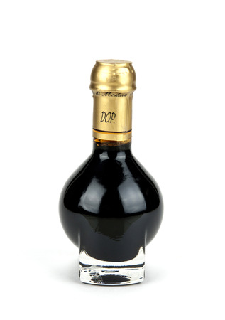 Traditional italian balsamic vinegar inside a special bottle isolated on white backgroundの写真素材