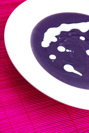 Violet potato and leek soup with cream.の写真素材