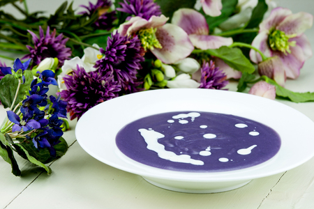 Violet potato and leek soup with cream.の写真素材