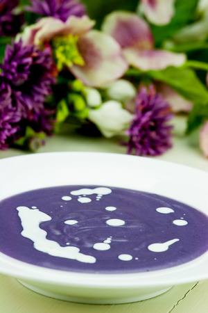 Violet potato and leek soup with cream.の写真素材