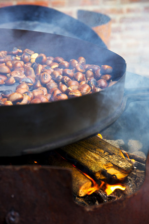 Organic Brown Chestnuts Roasting over a hot fire.の写真素材