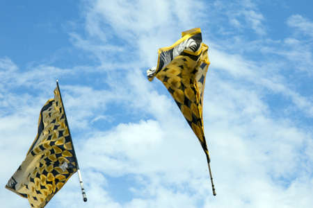 Traditional italian festival with flag throwers.Flags on the blue sky.の写真素材