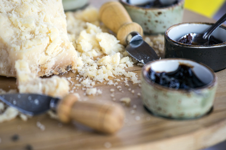 Pieces of italian parmesan cheese with cherry jam.の写真素材