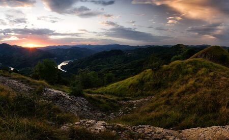 Above Garaventa: Panoramic view on the Lake at Sunrise with a beautiful deep cloudy Sky, Lago del Brugneto, Parco dell'Antola, Liguria, Italy, Europeの写真素材