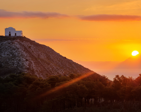The Sun darting its first Ray of the Day, San Costanzo Church, Punta Campanella, Amalfi coast, Province of Naples, Campania, Italyの写真素材