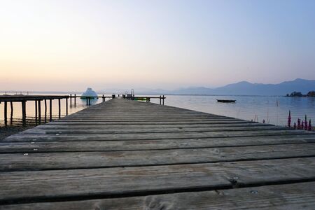 wonderful landing stage at sunset and mountains at horizon