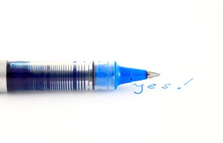 Blue pen wrote yesの写真素材